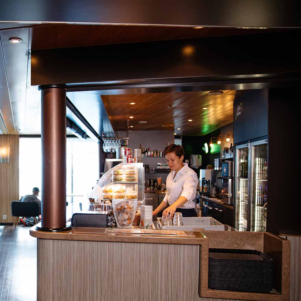 Bar Paja staff member behind the bar counter